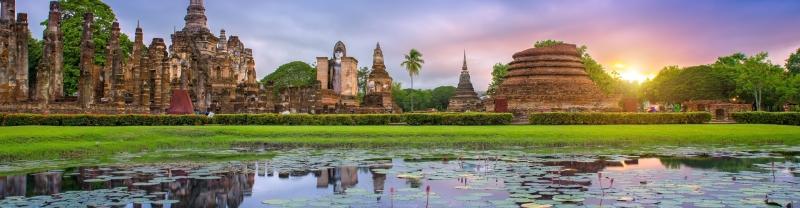 Sunset at Sukhothai ancient ruins lake and temples