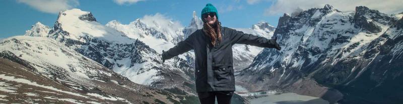 Woman standing in front of glaciers in Patagonia