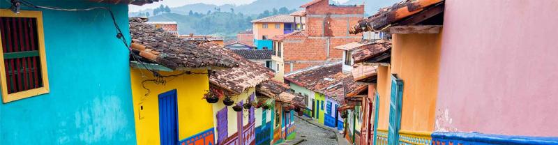 Colourful colonial houses along cobblestone street in Guatape, Antioquia, Colombia