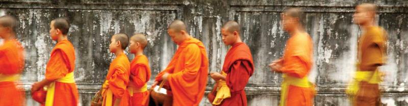 Young monks in a line during Alms giving ceremony in Luang Prabang, Laos