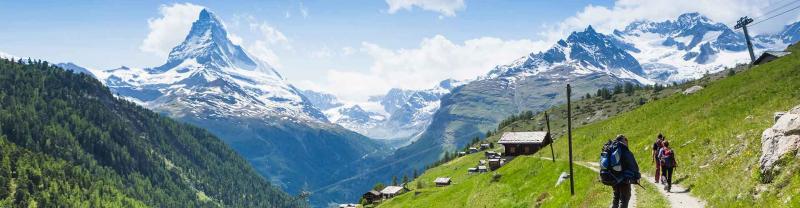 Travellers hike through the swiss alps