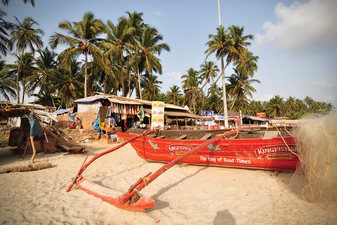 Red boat on Goa Beach in India