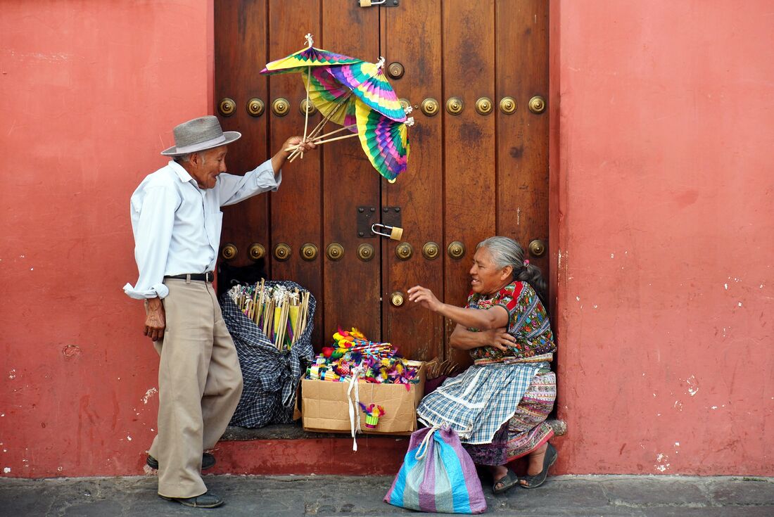 Locals selling goods in the colourful streets of Antigua