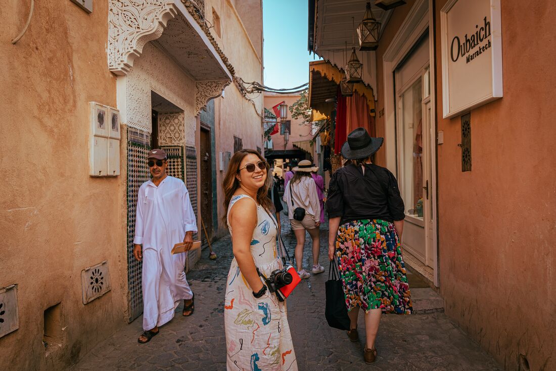 Intrepid traveller looks back as they walk through the markets and streets of Medina, Morocco