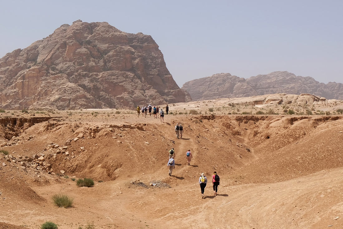 Group of travellers hiking through Petra, Jordan