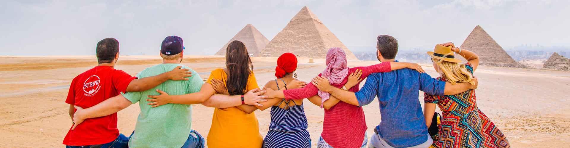 Group of travellers marvel at the pyramids in Cairo