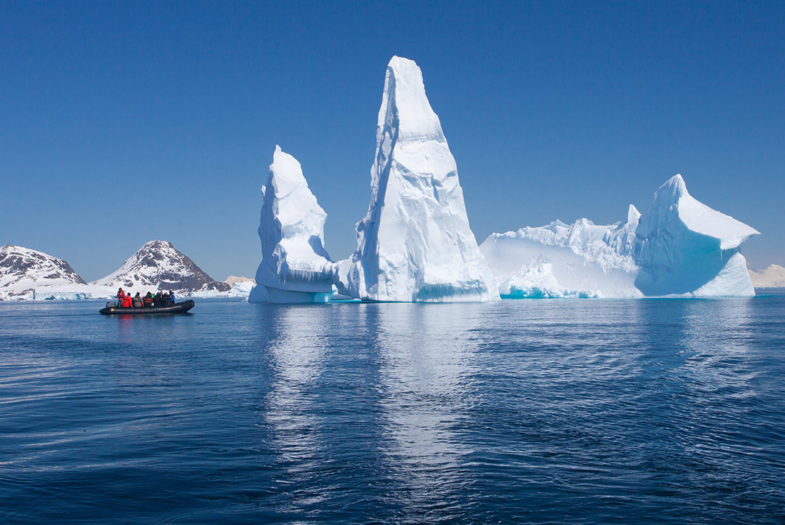 Iceberg with zodiac boat