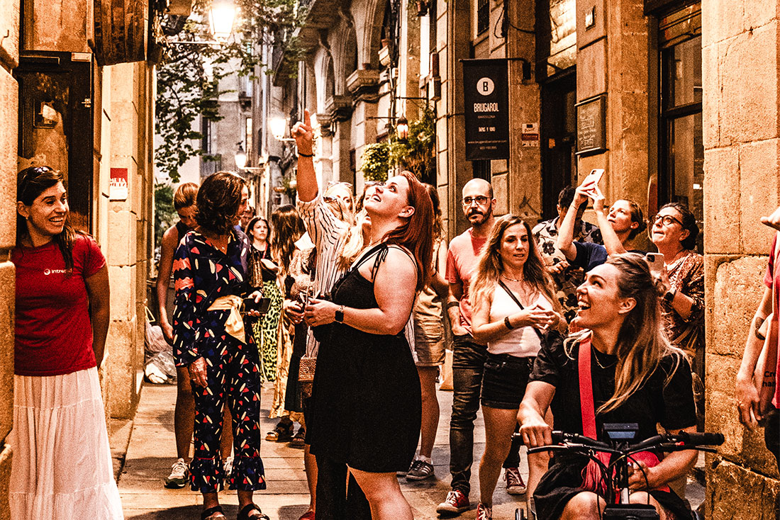 Group of Intrepid travellers look on amazed amidst the streets of Barcelona, Spain