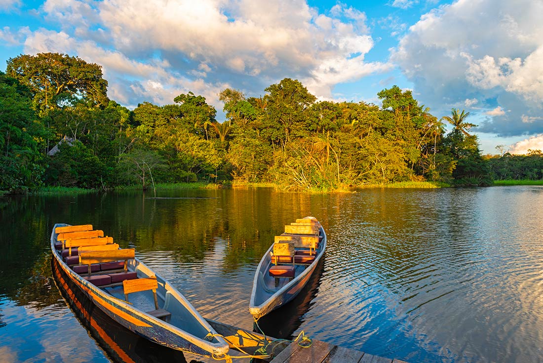 Wooden river boats moored on a small jetty on the Amazon river, Ecuador