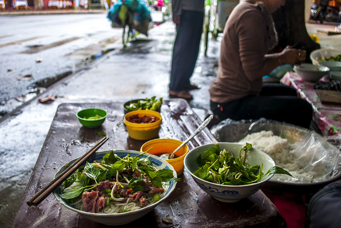 Enjoying a bowl of fresh Pho on a street stall in Vietnam