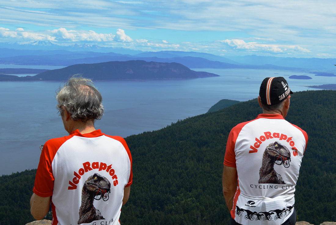 SSXJ - Two cyclists looking over the cliffs of San Juan Islands v