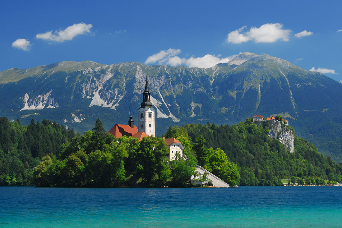 ZMPY - View of St. Mary's church across Lake Bled, Slovenia