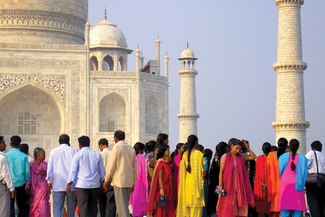 Locals in colourful attire at the Taj Mahal in India.