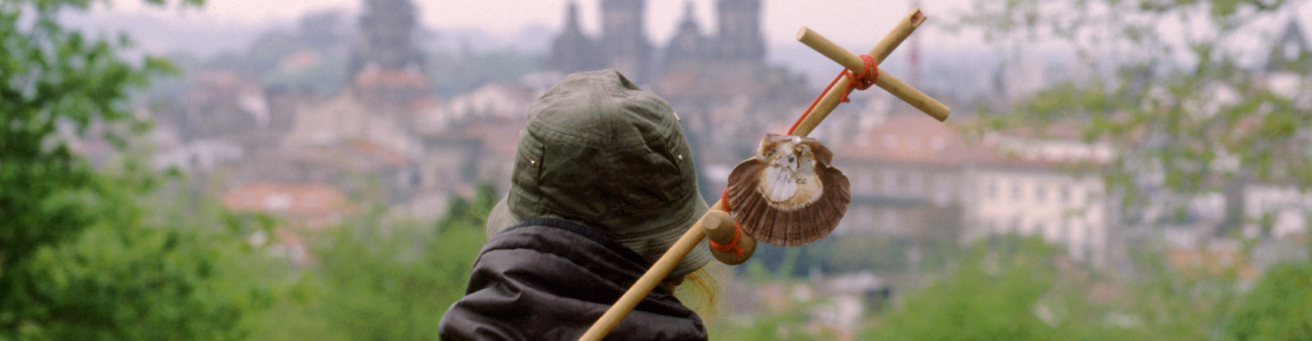 Traveller with backpack and shell for his pilgrimage in Camino de Santiago