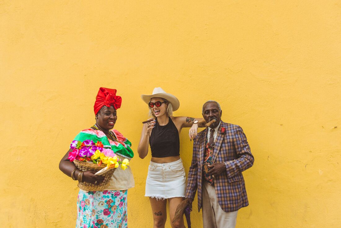Intrepid traveller laughs and has fun with locals in the streets of Havana