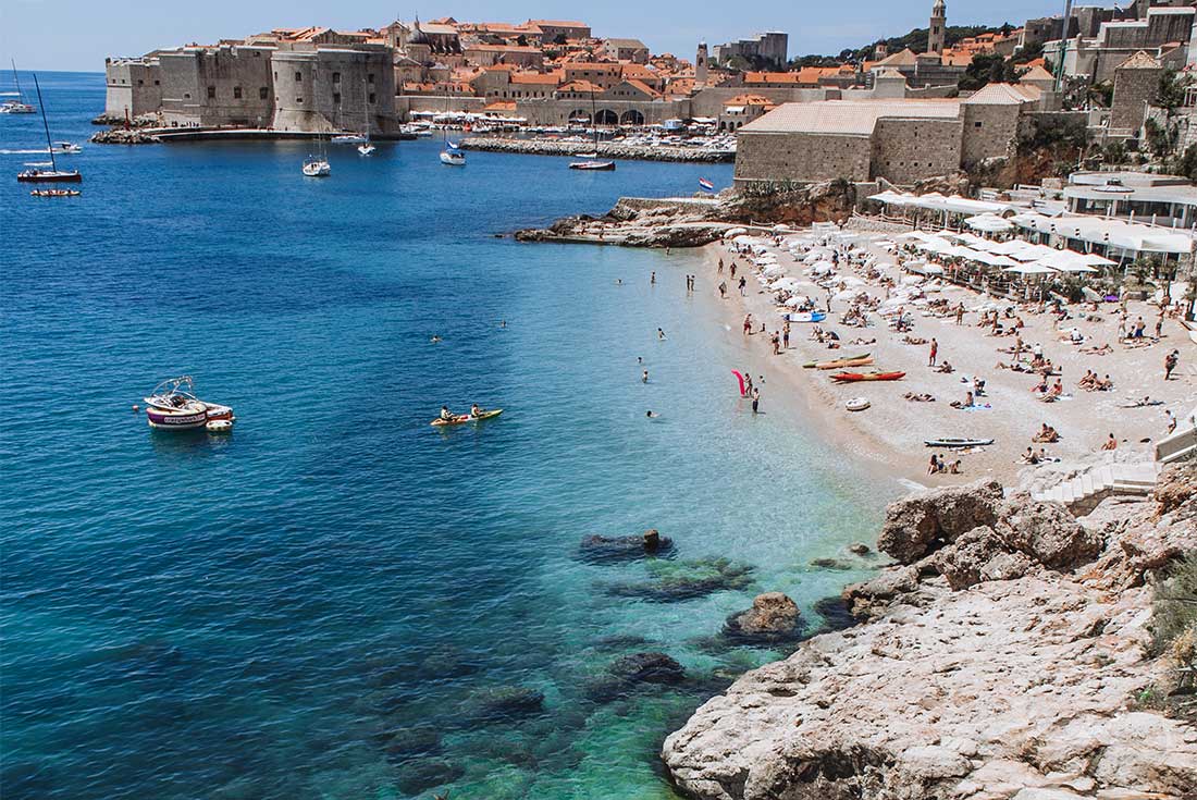Travellers and locals swim in the local beaches that hug the coastline of Dubrovnik