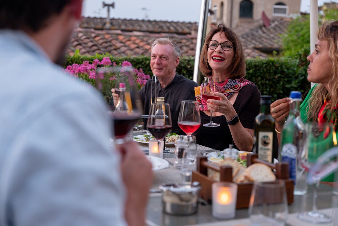Travellers enjoy dinner in San Gimignano