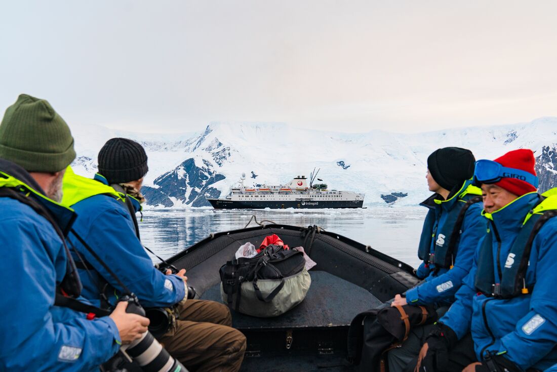 Intrepid travellers riding a zodiac back to the Ocean Endeavour off the Antarctic coast