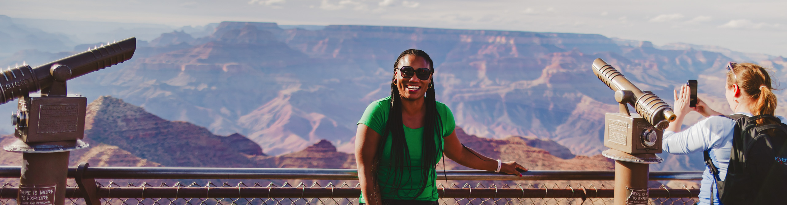 Traveller at Lookout over Grand Canyon smiling and having their picture taken, Arizonal, USA