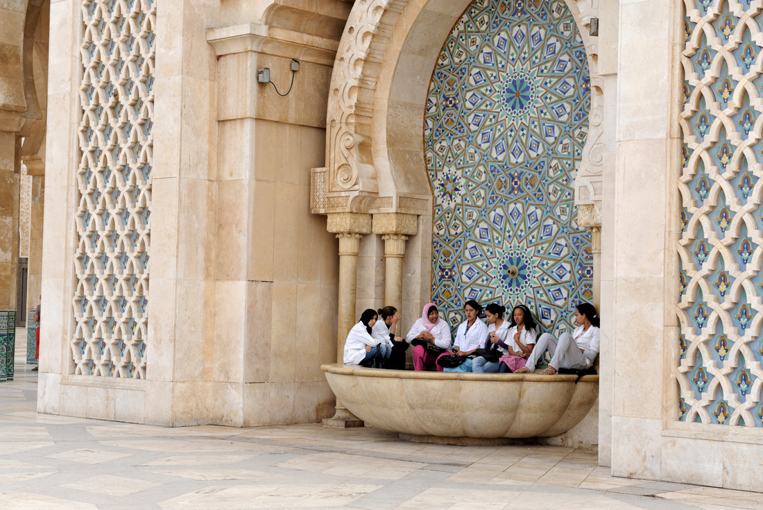 Peregrine Adventures morocco casablanca locals sitting mosque