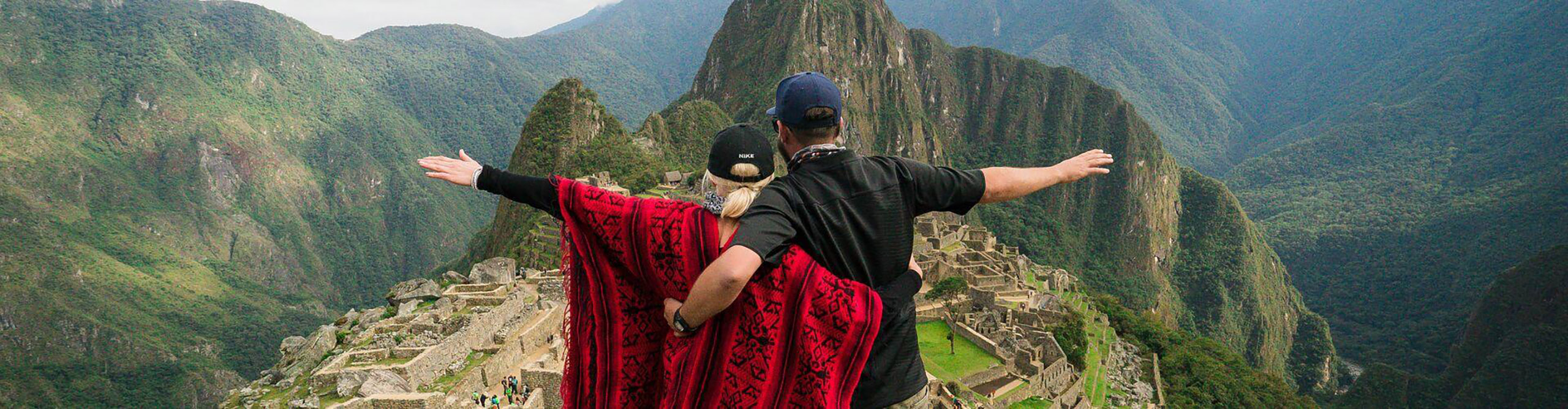 Couple looking at Machu Picchu Peru