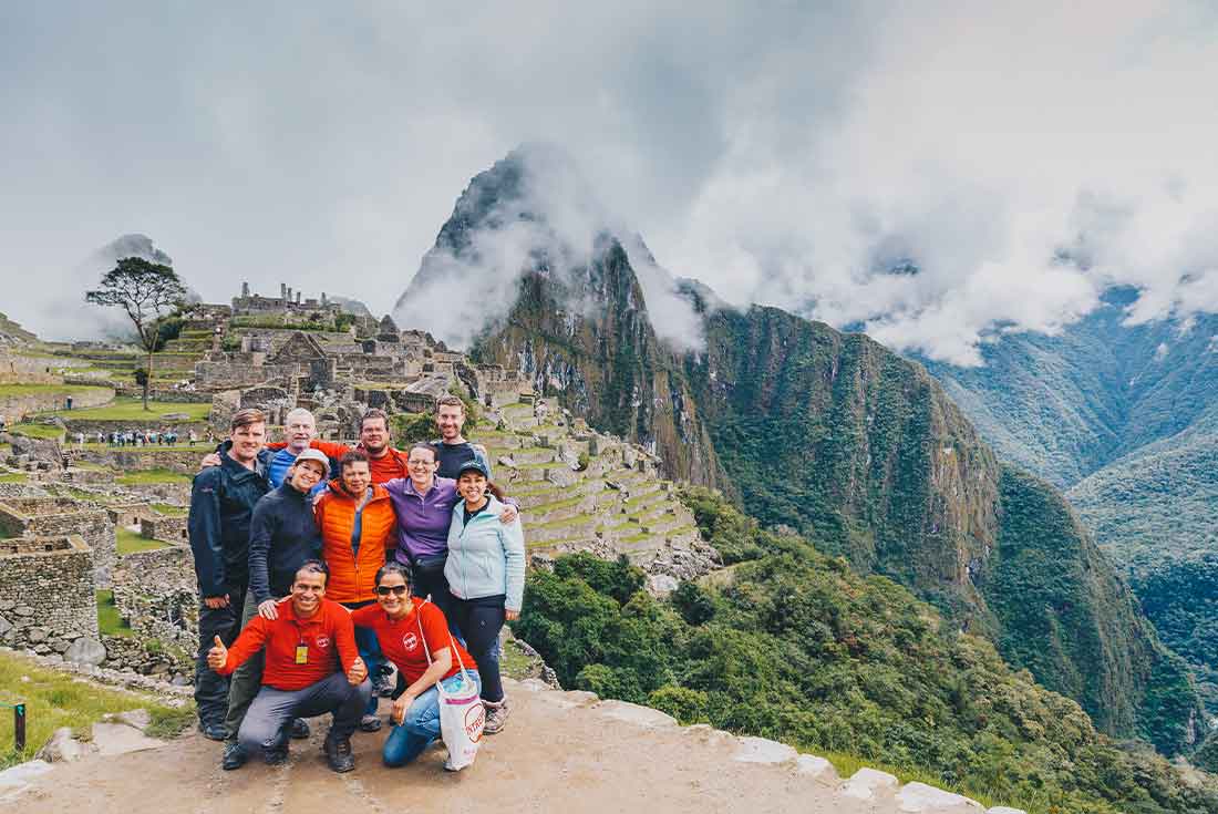 Group of hikers summit Machu Picchu 