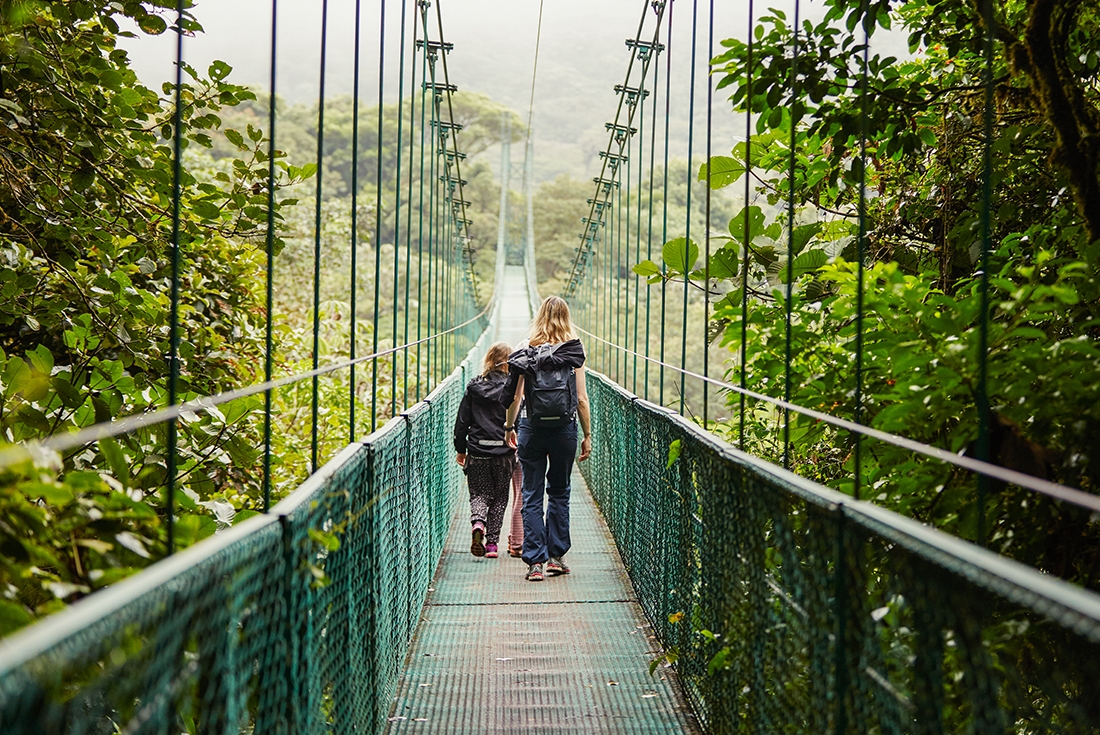 Mother and child on a suspension bridge in Monteverde