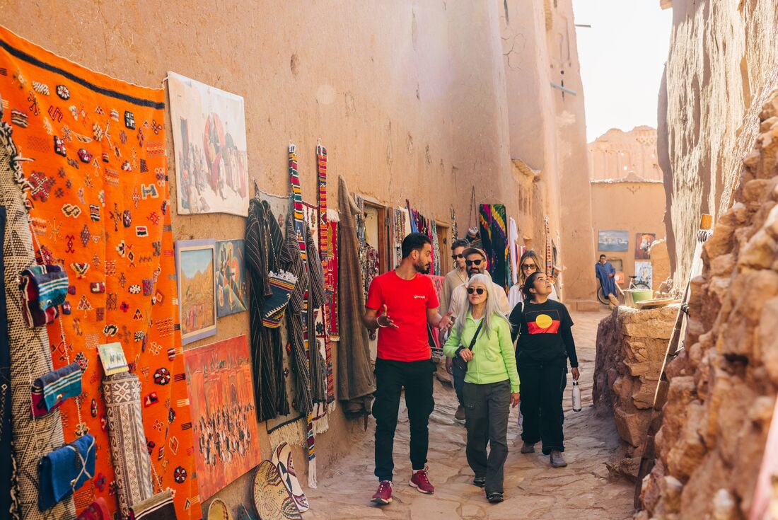 Intrepid leader taking travellers on a guided tour of Ait Benhaddou, Morocco