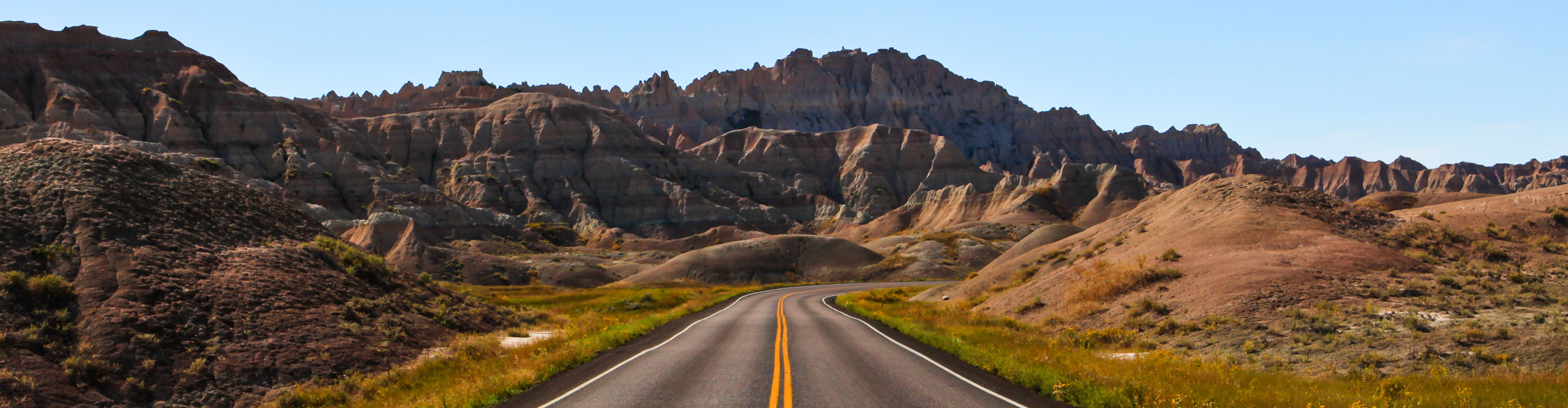 long straight road  in Badlands National Park, South Dakota, on a clear sunny day