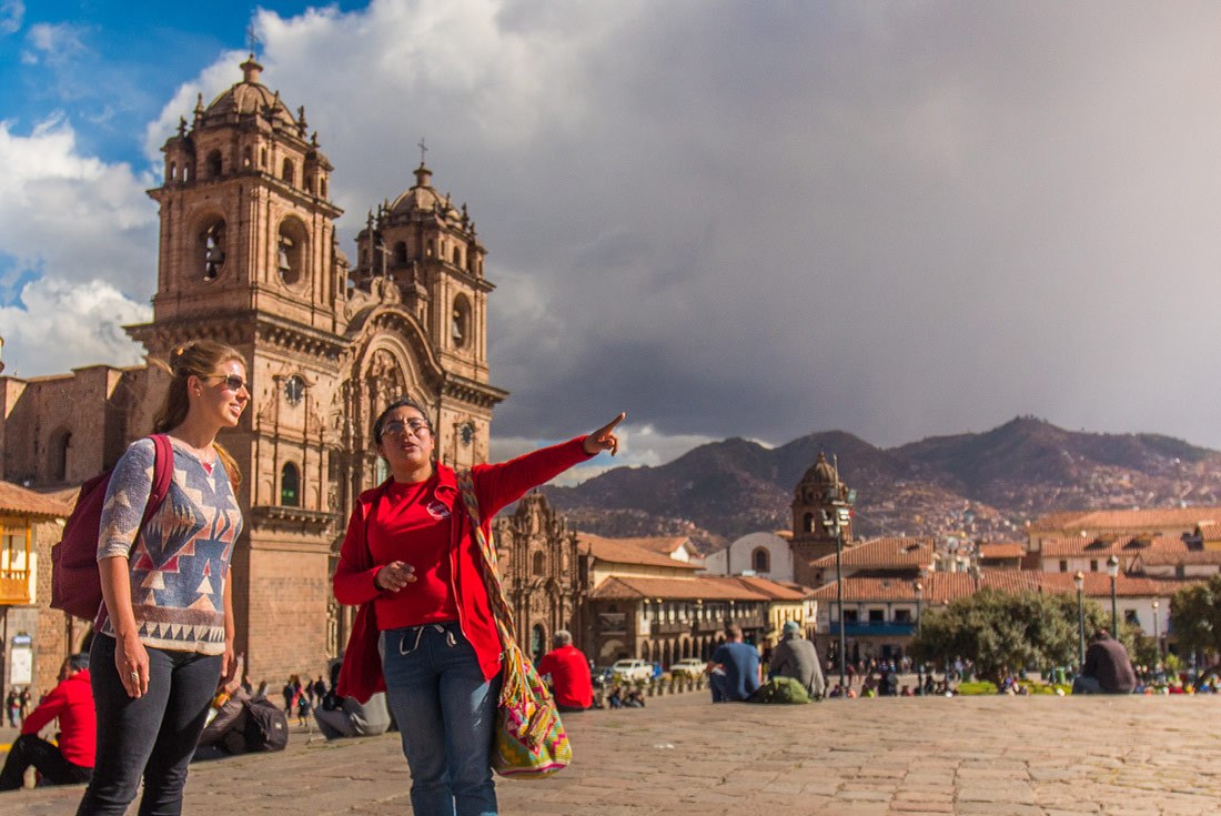 GGPP - Tour leader with female traveller touring Plaza de Arma, Cusco
