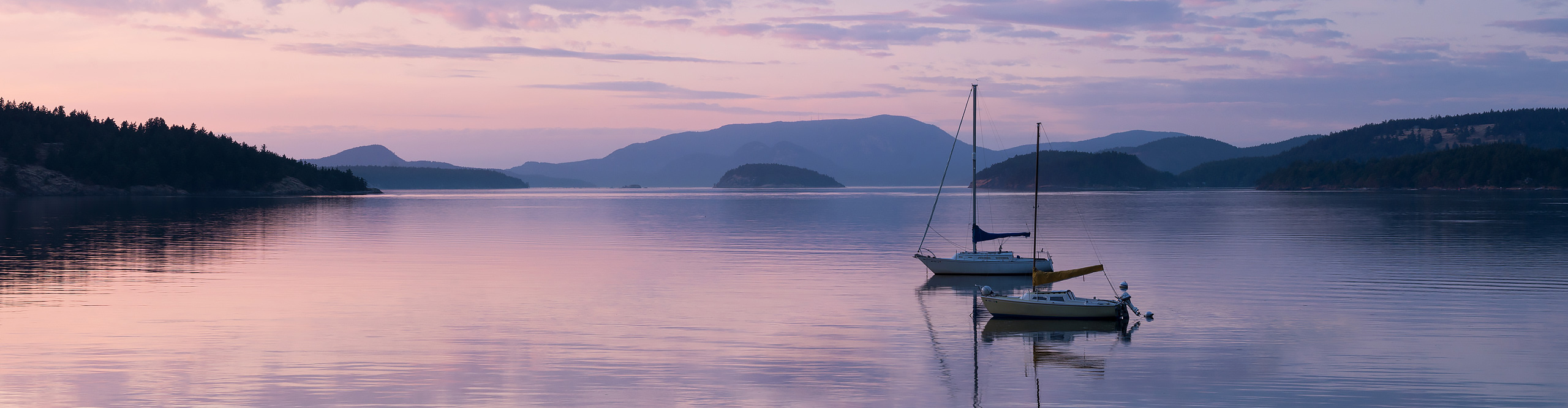 San Juan islands at dusk, with a purple sky and Orcas island in the distance, USA