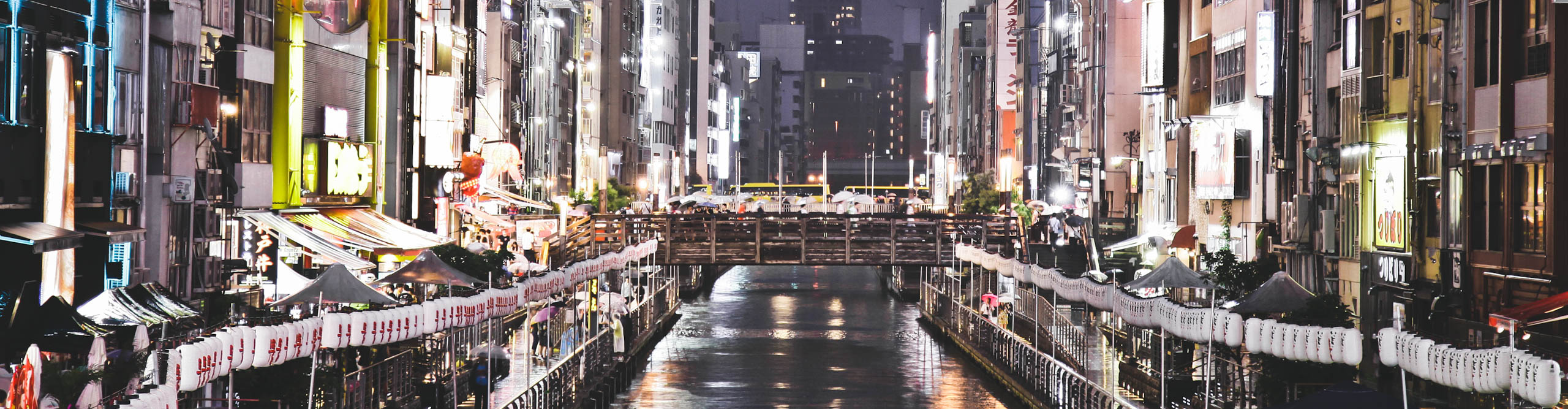 Neon lights of Osaka over the river at night, Japan