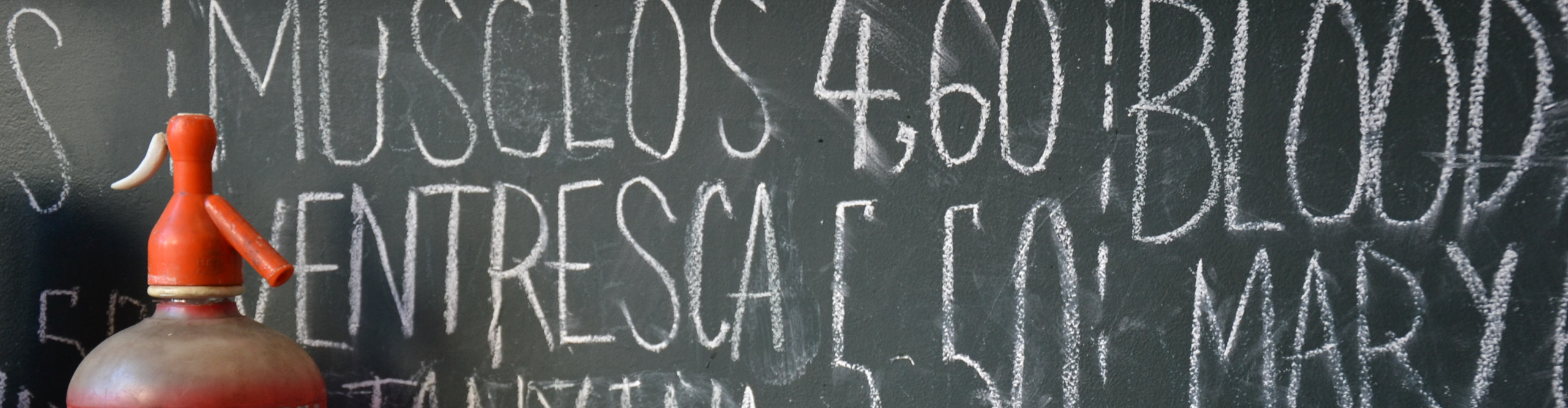 Spanish phrases written on a blackboard 