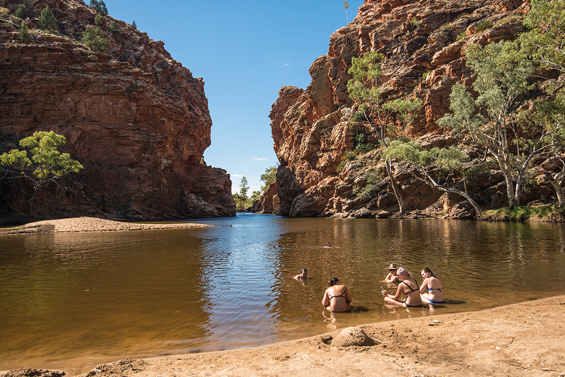 Enjoying a cooling swim in Ellery Big Hole in the West Macdonnell Ranges in the Northern Territory, Australia