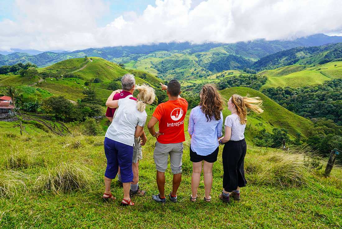 Intrepid travellers and leader look out at a beautiful hill landscape near Monteverde, Costa Rica