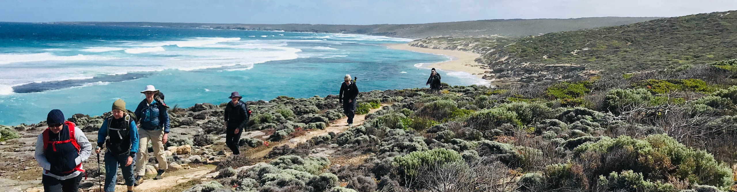 Hikers near the beach on Kangaroo Island on a clear sunny day, Australia