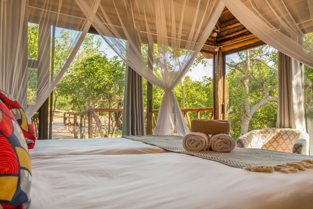 View of bed and balcony at Panzi Lodge near Kruger National Park in South Africa