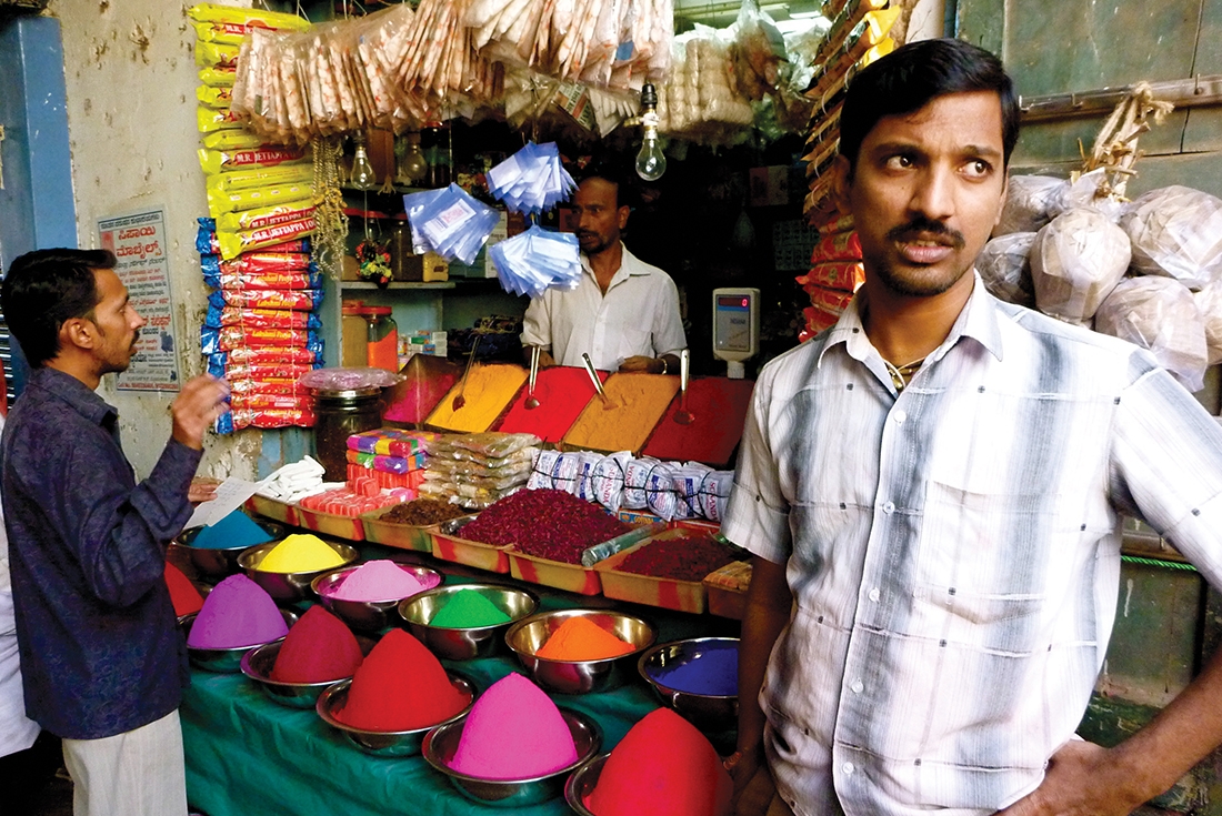 Local vendor selling spices in a market in Mysore, India