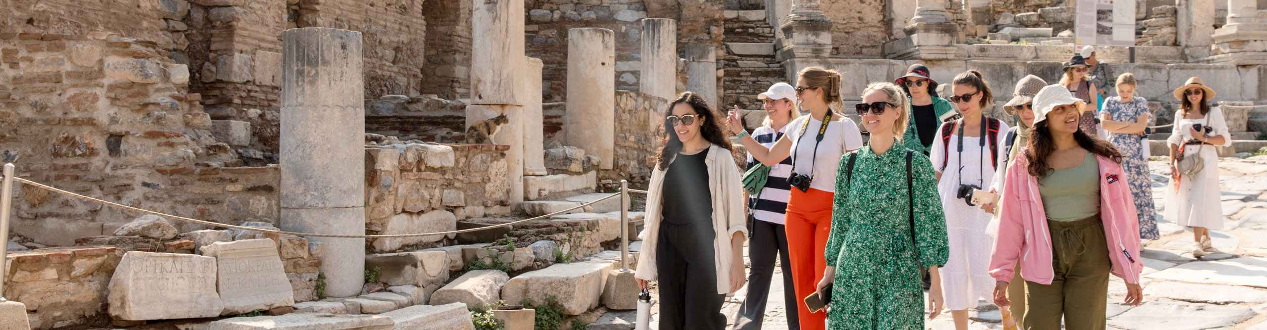Travellers walking near ephesus ruins in Turkey