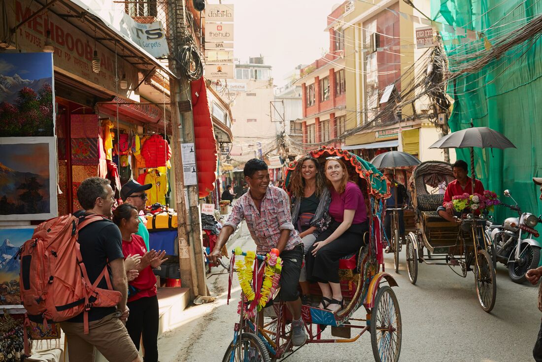 Travellers in a cycle-rickshaw in Kathmandu, Nepal