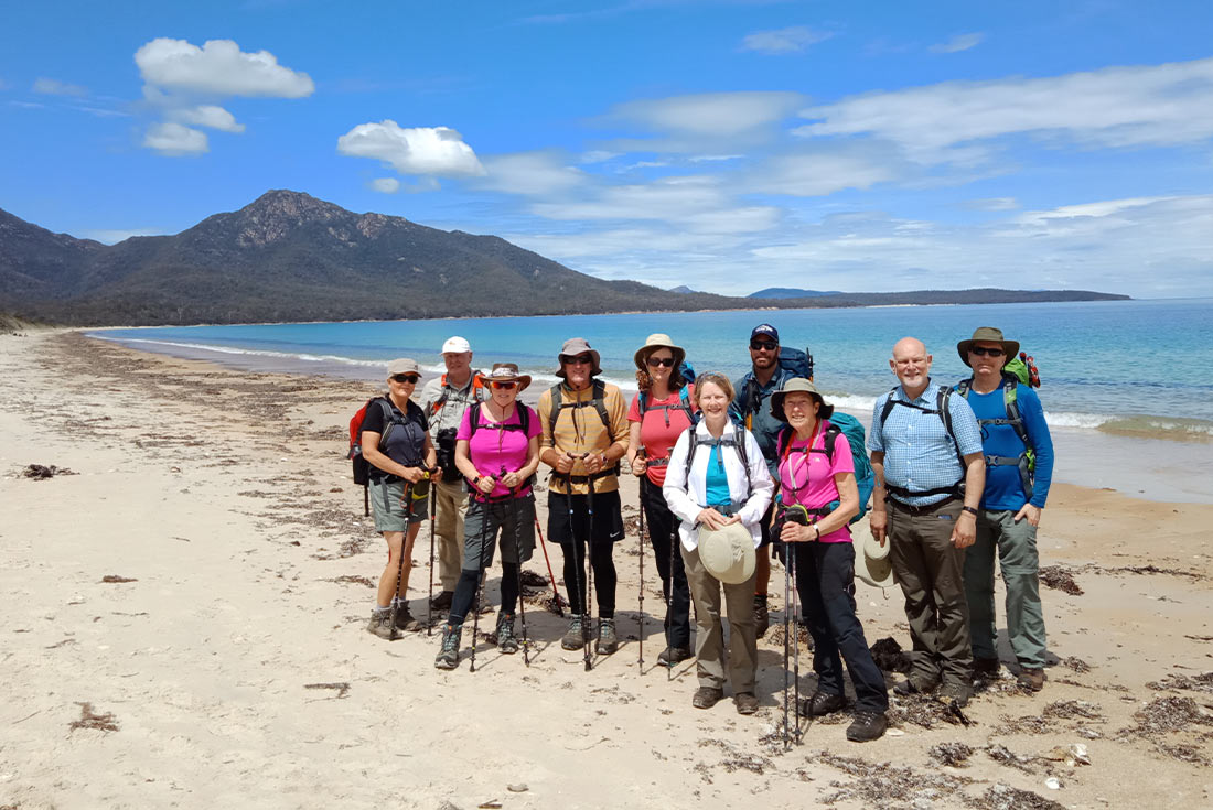Group of hikers at Wineglass Bay, Tasmania, Australia