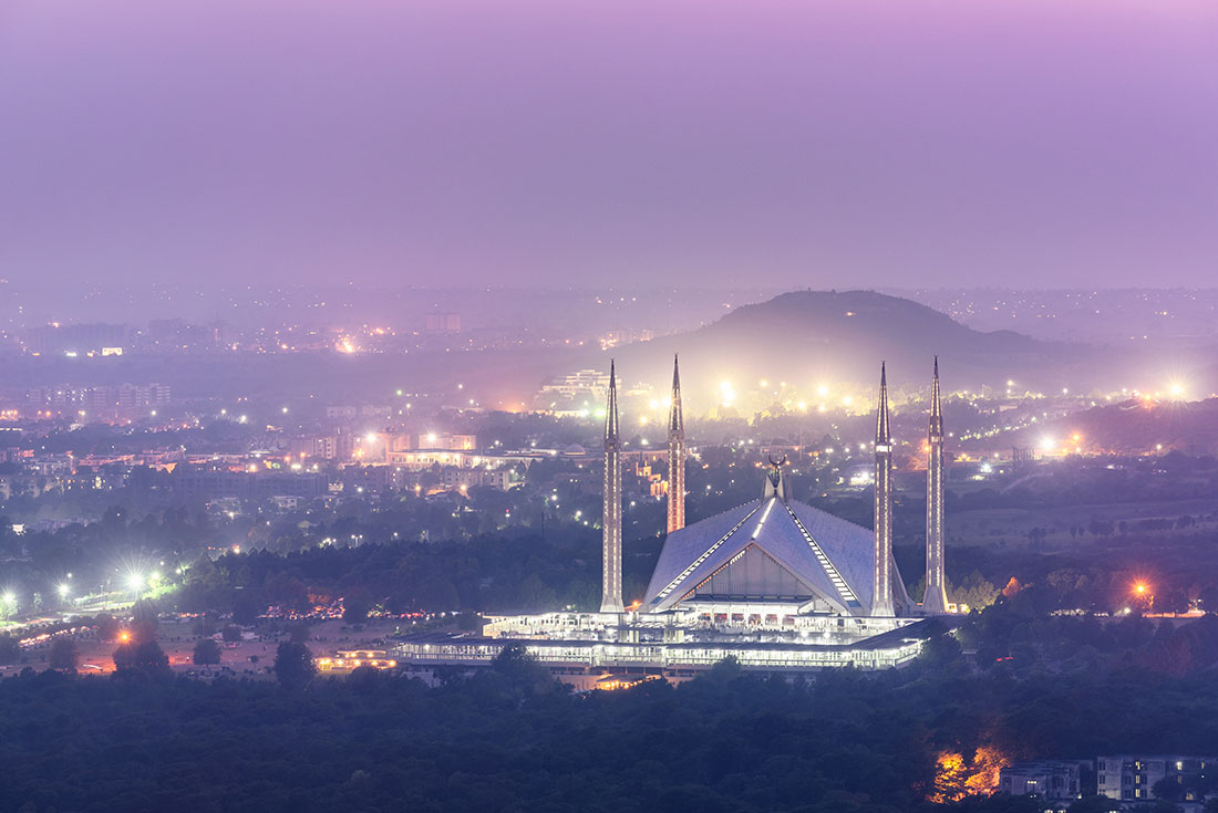 Aerial view of Faisal Mosque in Islamabad with purple sky 