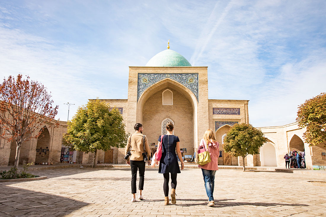Group of Intrepid travellers approach the Kukeldash Madrasah in Tashkent, Uzbekistan