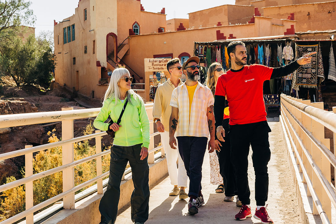 Group of Intrepid travellers are led by a leader on a tour through Ait Benhaddou