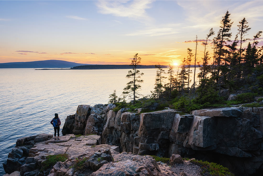 Single traveller watching sunset in Acadia National Park, Maine, U.S.A.