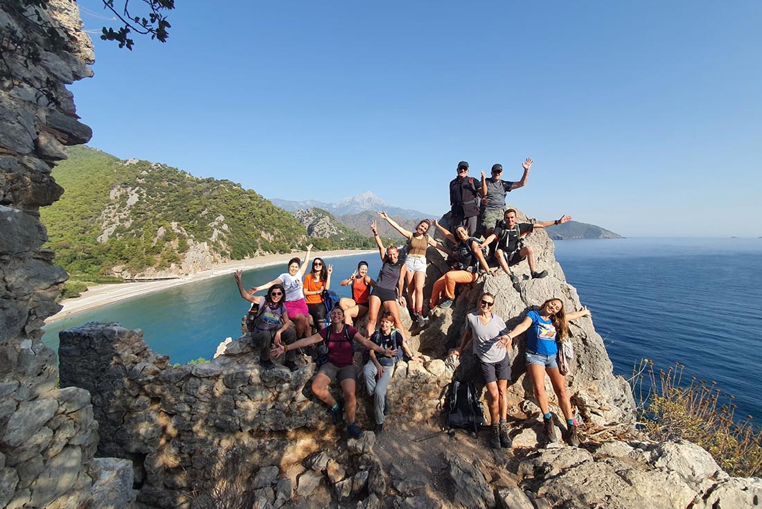 Group of hikers posing on rock along the Lycian Way, Turkey