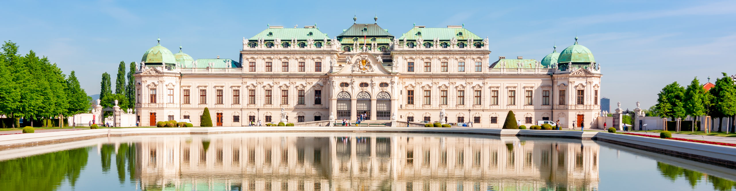 Belvedere Palace and gardens, reflected in the water on a sunny day in Vienna, Austria 