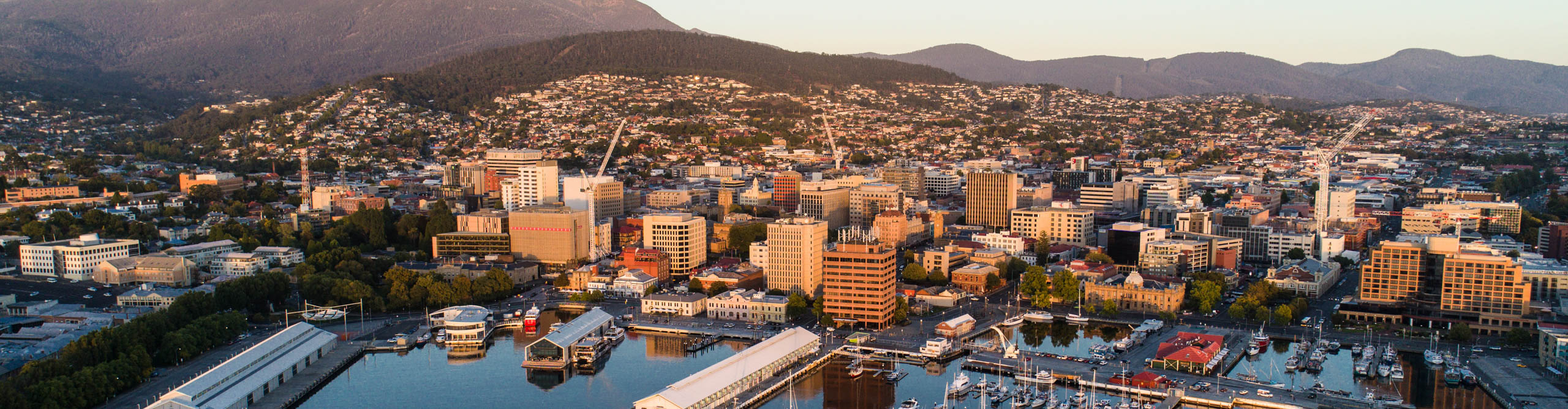 Sunset over Hobart harbour with building glowing brand own a clear day, Tasmania, Australia 