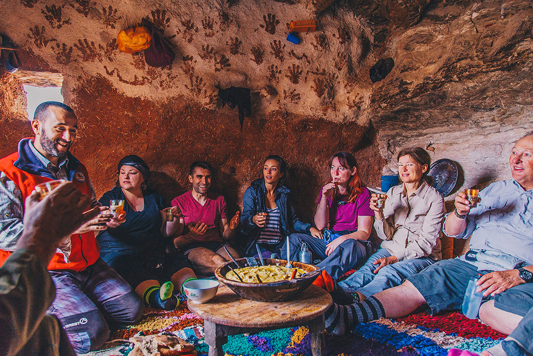 Group of travellers sharing traditional Berber food, Morocco