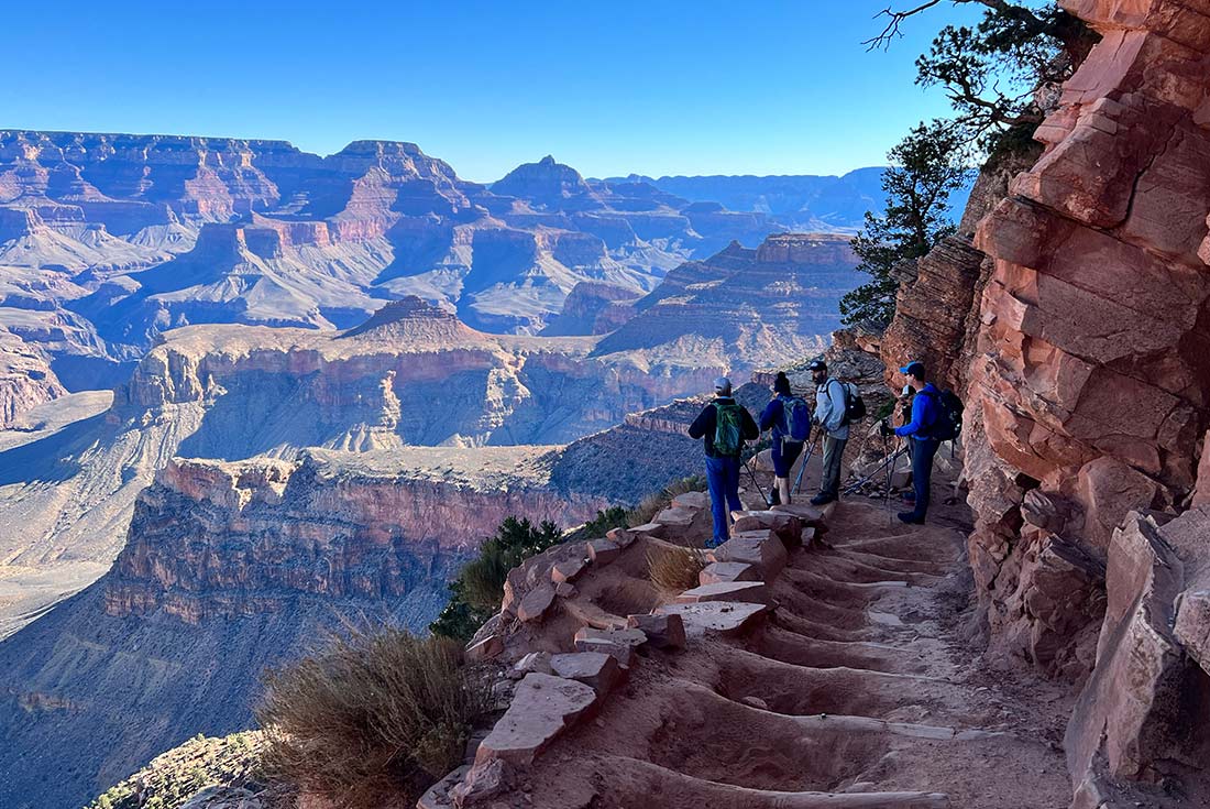 Travellers hiking along the Grand Canyon, overlooking the view in Arizona, U.S.A.